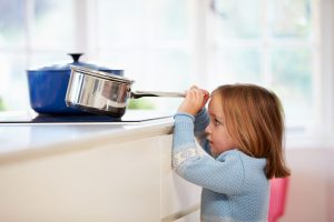 Young,Girl,Risking,Accident,With,Pan,In,Kitchen